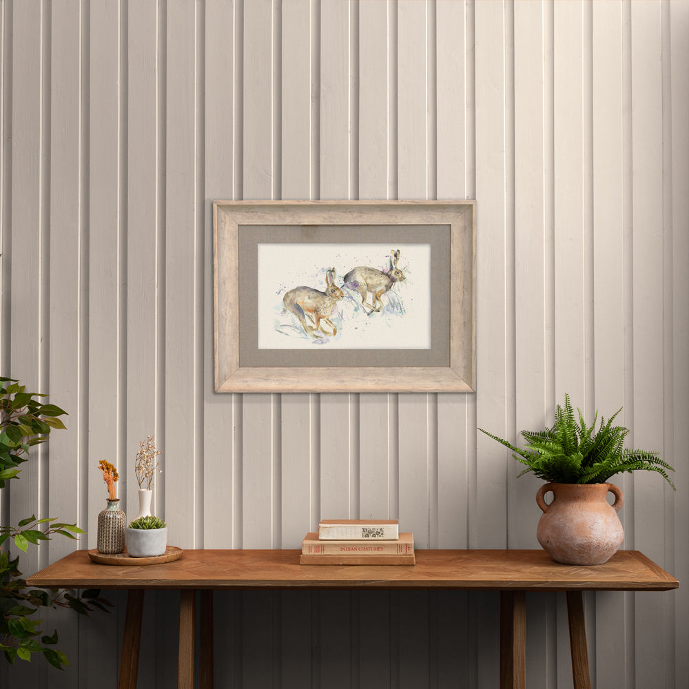 Hurtling Hares Framed Print