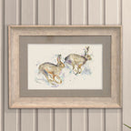 Hurtling Hares Framed Print