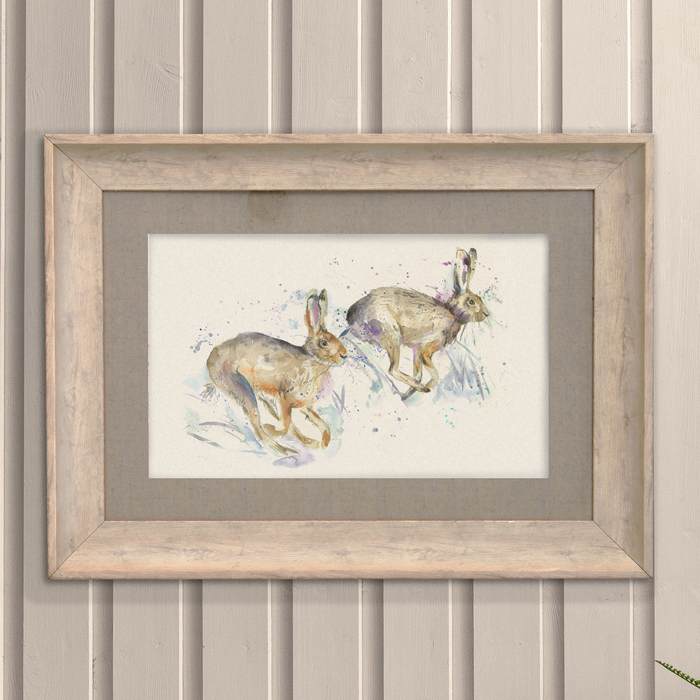 Hurtling Hares Framed Print