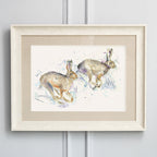 Hurtling Hares Framed Print